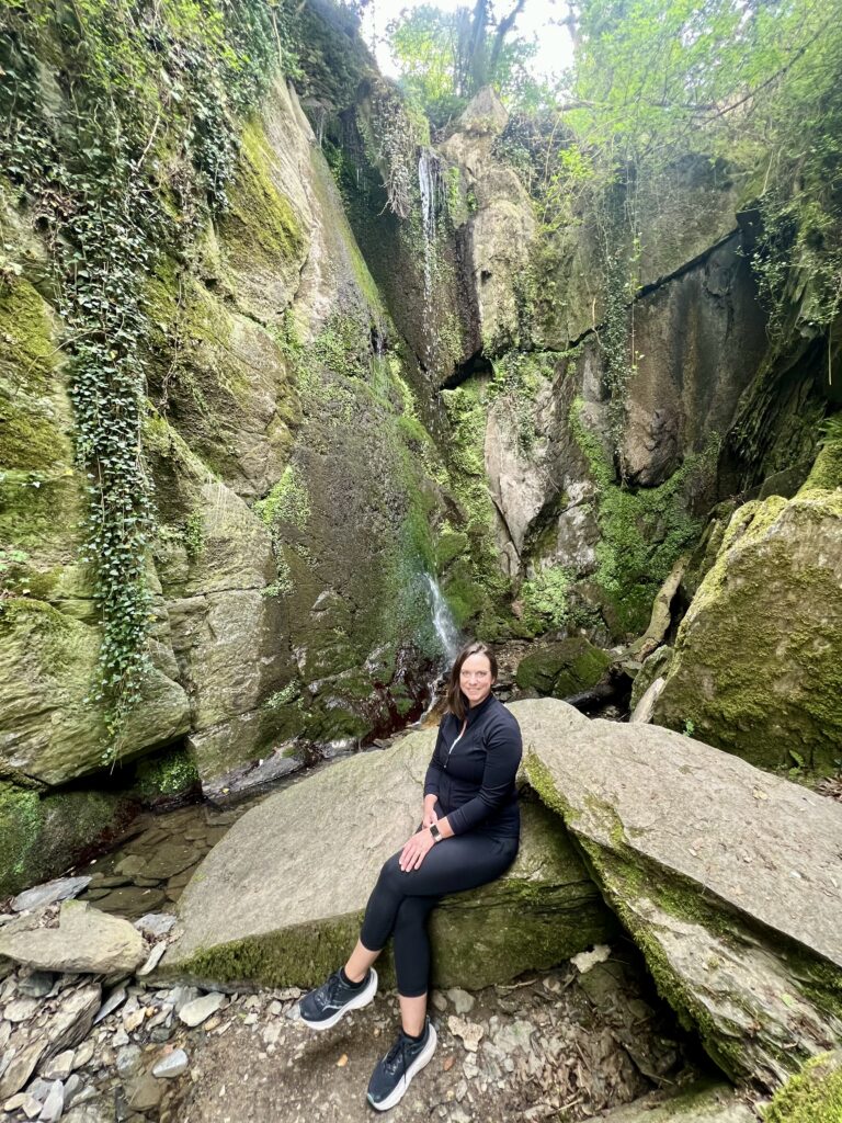 Light waterfall surrounded by mossy rocks